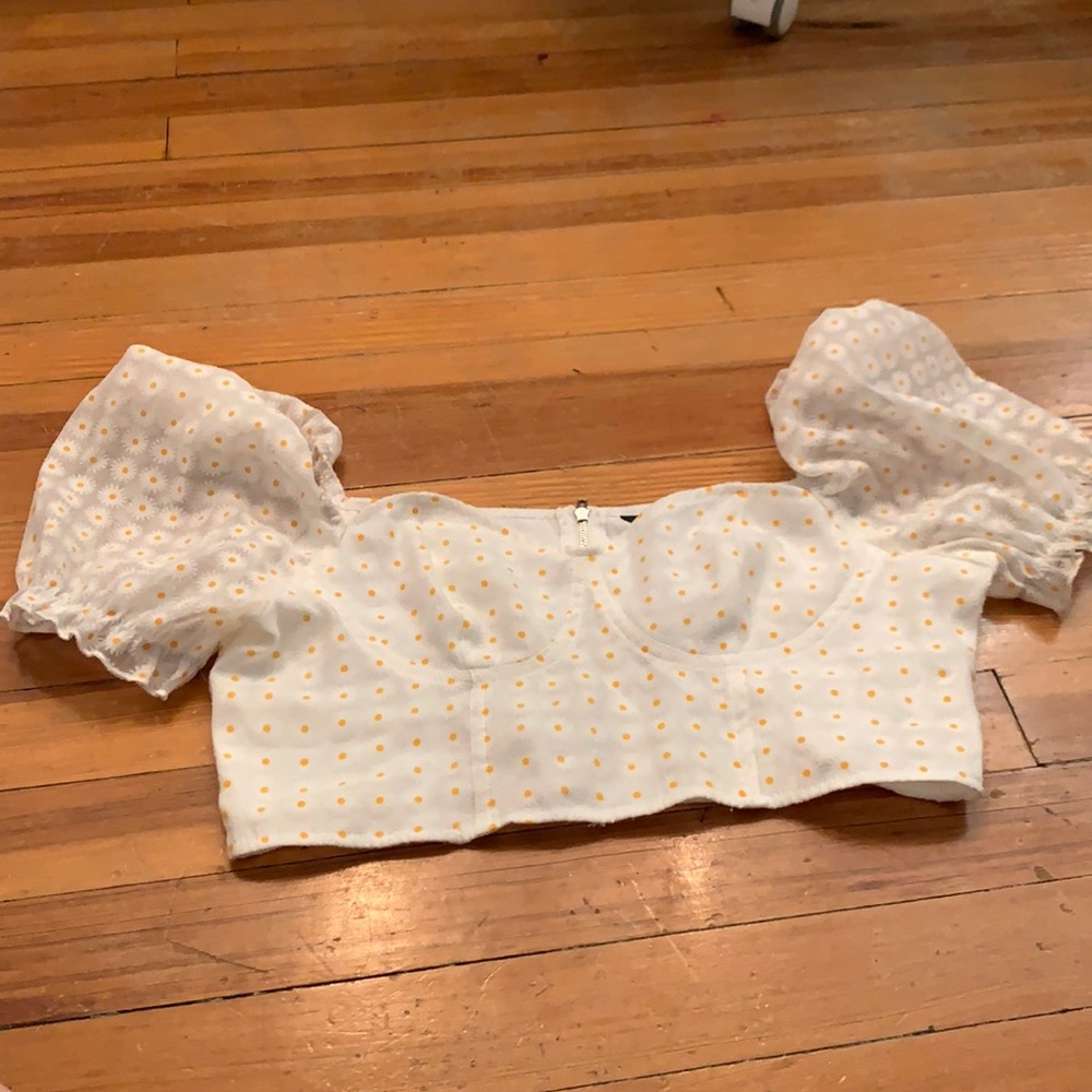 white sunflower top with puffed sleeves.